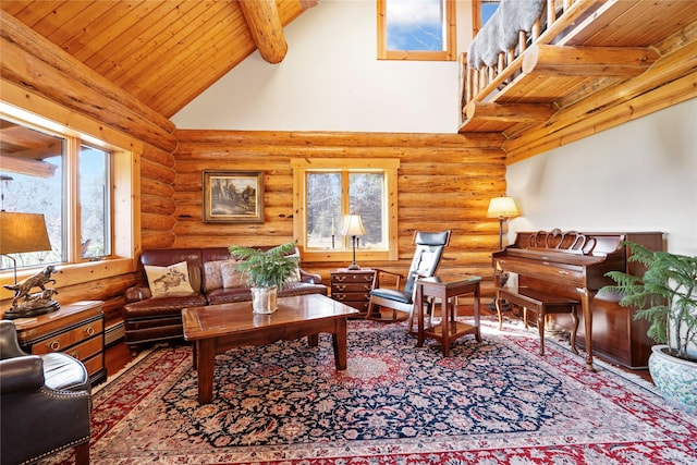 182 Moondance Trl, Bigfork, MT 59911 - living area with log walls, high vaulted ceiling, a wood ceiling with exposed beams, baseboard heating, and wood finished floors