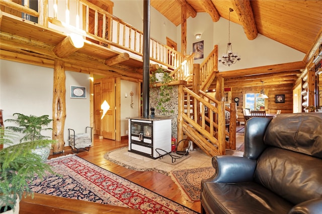 182 Moondance Trl, Bigfork, MT 59911 - living room with log walls, hardwood / wood-style floors, stairs, a wooden ceiling with exposed beams, and high vaulted ceiling