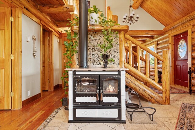 182 Moondance Trl, Bigfork, MT 59911 - detailed view of rustic walls, a wooden ceiling with exposed beams, a chandelier, a wood stove, and wood finished floors