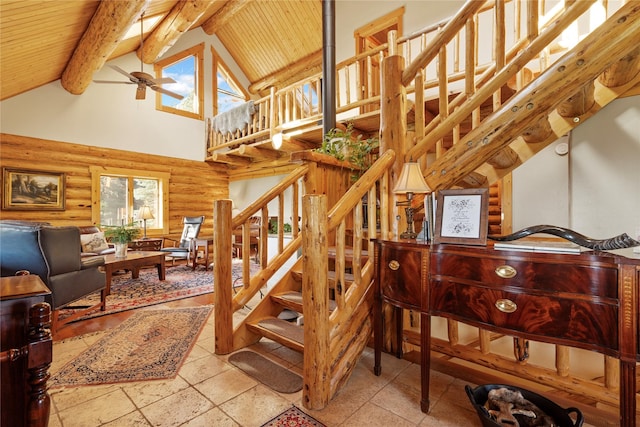 182 Moondance Trl, Bigfork, MT 59911 - stairway with rustic walls, high vaulted ceiling, a ceiling fan, and a wooden ceiling with exposed beams