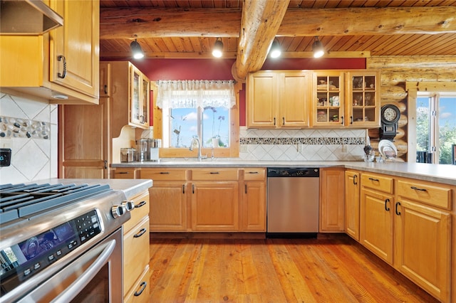 182 Moondance Trl, Bigfork, MT 59911 - kitchen featuring stainless steel appliances, under cabinet range hood, a wooden ceiling with exposed beams, light wood-type flooring, and backsplash