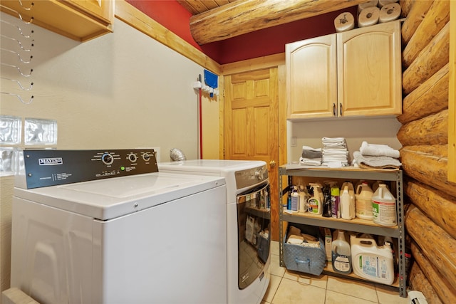 182 Moondance Trl, Bigfork, MT 59911 - laundry room featuring log walls, cabinet space, washing machine and dryer, and light tile patterned floors
