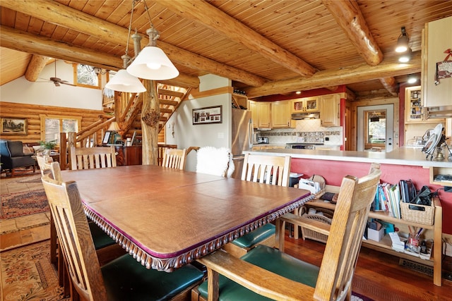 182 Moondance Trl, Bigfork, MT 59911 - dining room featuring a wooden ceiling with exposed beams, rustic walls, healthy amount of natural light, a ceiling fan, and wood finished floors