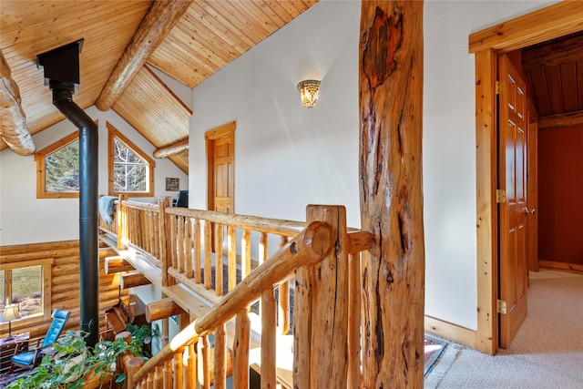 182 Moondance Trl, Bigfork, MT 59911 - hall with rustic walls, wood ceiling, carpet flooring, and an upstairs landing