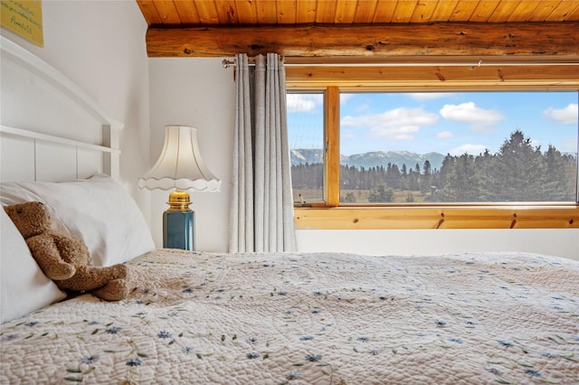 182 Moondance Trl, Bigfork, MT 59911 - bedroom featuring a wooden ceiling with exposed beams and a mountain view