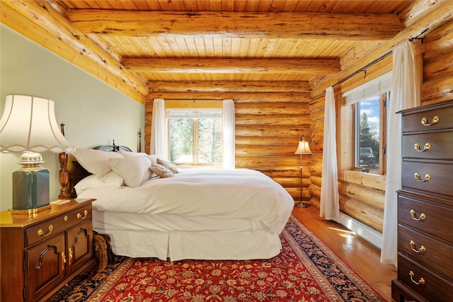 182 Moondance Trl, Bigfork, MT 59911 - bedroom featuring rustic walls, a wood ceiling with exposed beams, and wood finished floors