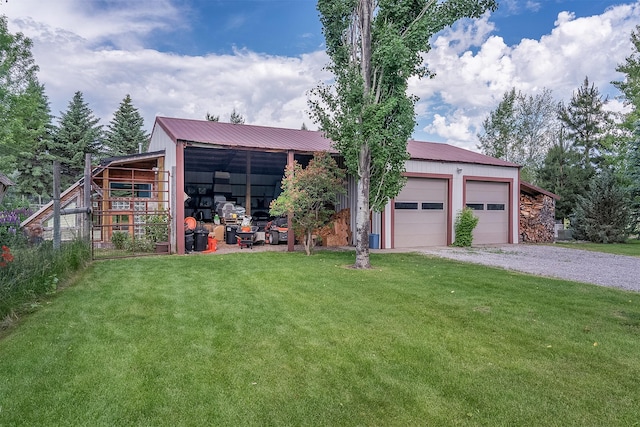 182 Moondance Trl, Bigfork, MT 59911 - view of front of property featuring a front lawn, an outbuilding, and a metal roof