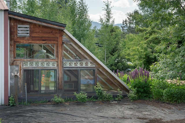 182 Moondance Trl, Bigfork, MT 59911 - view of home's exterior featuring a mountain view and a greenhouse