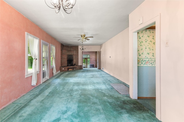 3101 Mt Highway 206, Columbia Falls, MT 59912 - unfurnished living room featuring carpet floors, a fireplace, a ceiling fan, and a chandelier