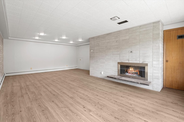 1695 Whalebone Dr, Kalispell, MT 59901 - unfurnished living room with wood finished floors, a brick fireplace, and a baseboard heating unit