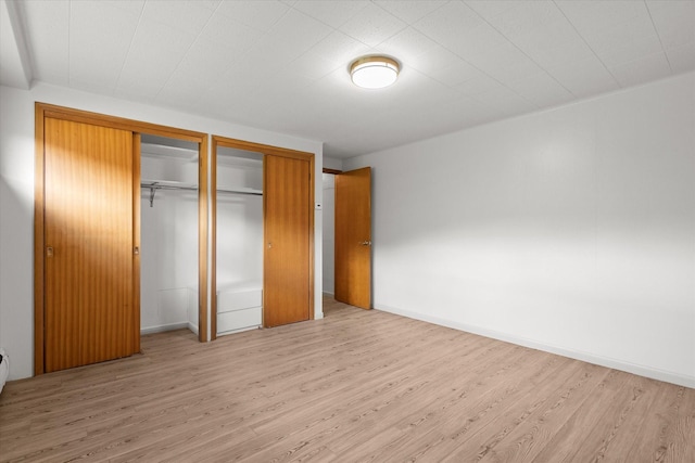 1695 Whalebone Dr, Kalispell, MT 59901 - unfurnished bedroom with light wood-style flooring and multiple closets