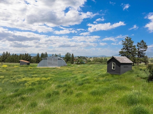 1695 Whalebone Dr, Kalispell, MT 59901 - view of yard with a storage unit and a mountain view