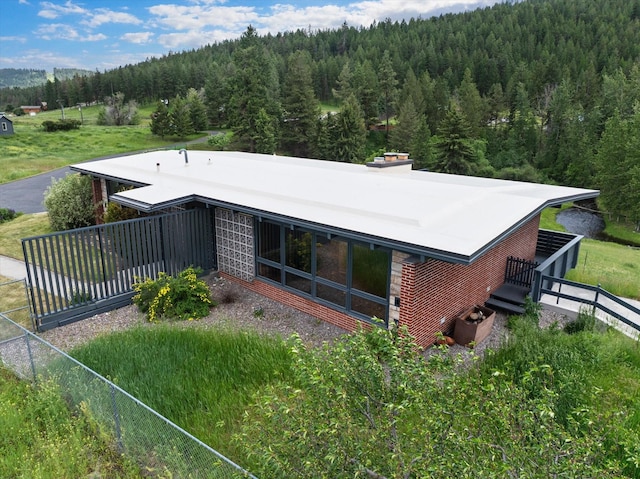 1695 Whalebone Dr, Kalispell, MT 59901 - rear view of house featuring a forest view