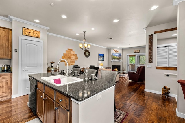 6203 Monterra Ave Unit H, Whitefish, MT 59937 - kitchen with ornamental molding, recessed lighting, a lit fireplace, dark wood-type flooring, and dishwasher