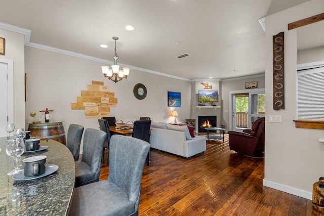 6203 Monterra Ave Unit H, Whitefish, MT 59937 - dining room with a chandelier, wood finished floors, crown molding, a lit fireplace, and recessed lighting