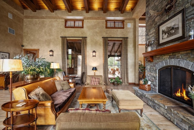 6203 Monterra Ave Unit H, Whitefish, MT 59937 - living area with a wooden ceiling with exposed beams, wood finished floors, a stone fireplace, and a towering ceiling