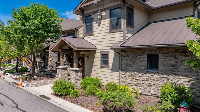 6203 Monterra Ave Unit H, Whitefish, MT 59937 - view of front of home featuring stone siding, a standing seam roof, and a metal roof