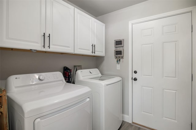 3806 Timothy Ln, Helena, MT 59602 - washroom with washing machine and dryer, cabinet space, and wood finished floors