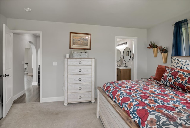 3806 Timothy Ln, Helena, MT 59602 - bedroom featuring light carpet, arched walkways, and ensuite bath