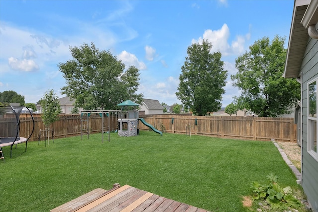 3806 Timothy Ln, Helena, MT 59602 - fenced backyard with a playground, a trampoline, and a wooden deck