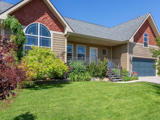 521 Evening Star Ln, Columbia Falls, MT 59912 - view of front of house with a shingled roof, a front lawn, concrete driveway, and a garage