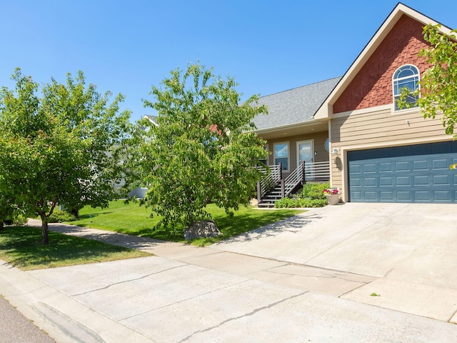 521 Evening Star Ln, Columbia Falls, MT 59912 - view of front of house featuring driveway, a front lawn, and a garage