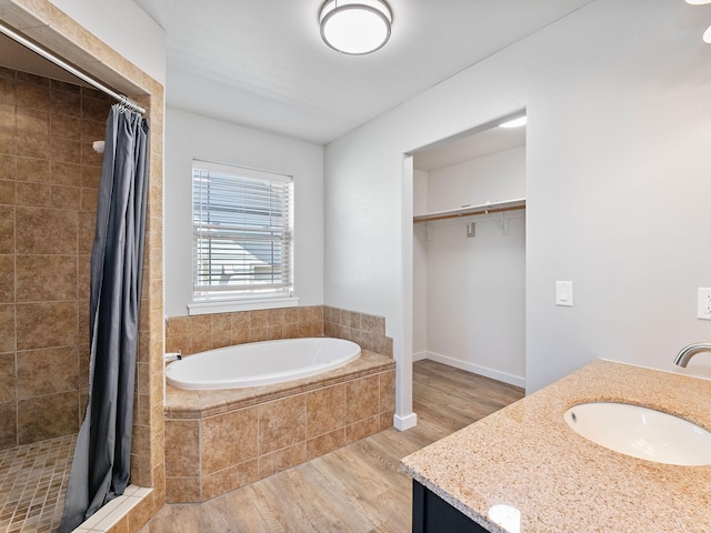 521 Evening Star Ln, Columbia Falls, MT 59912 - bathroom with wood finished floors, vanity, a stall shower, and a garden tub