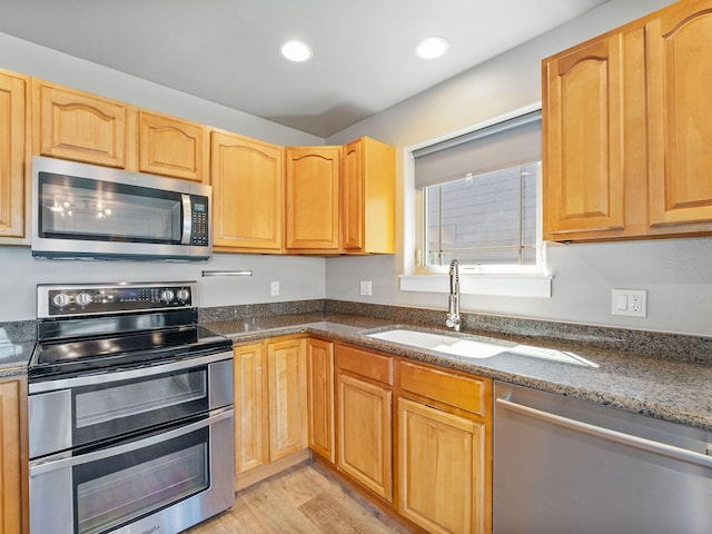 521 Evening Star Ln, Columbia Falls, MT 59912 - kitchen with appliances with stainless steel finishes, recessed lighting, light wood-style floors, and dark stone countertops