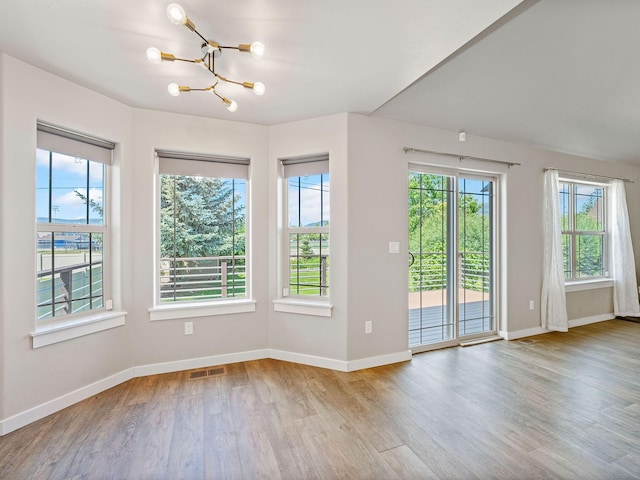 521 Evening Star Ln, Columbia Falls, MT 59912 - spare room featuring a chandelier and wood finished floors