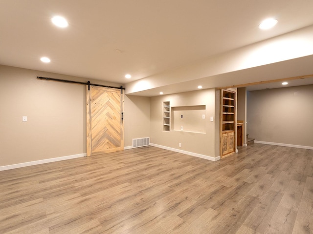 521 Evening Star Ln, Columbia Falls, MT 59912 - finished below grade area with recessed lighting, a barn door, light wood finished floors, and built in features