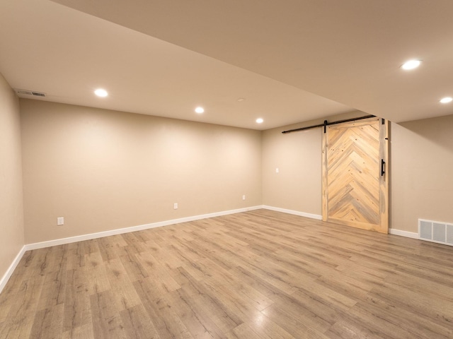 521 Evening Star Ln, Columbia Falls, MT 59912 - finished basement with a barn door, recessed lighting, and light wood-type flooring