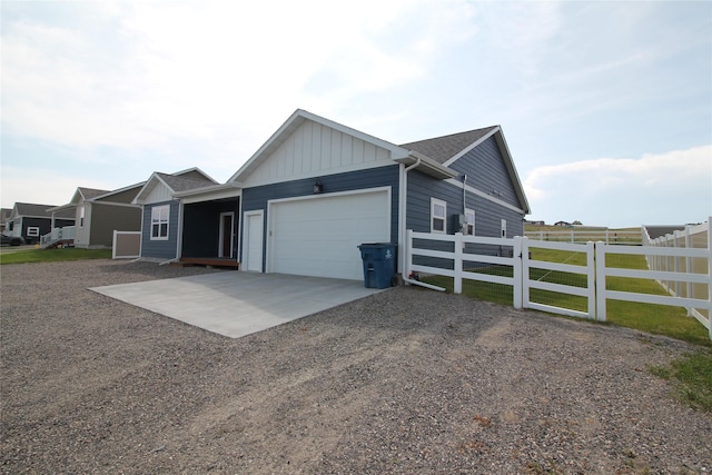 506 Mountain View Dr, Cascade, MT 59421 - view of front facade featuring gravel driveway, an attached garage, and board and batten siding