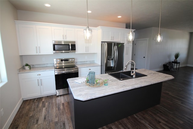 506 Mountain View Dr, Cascade, MT 59421 - kitchen with stainless steel appliances, dark wood-style floors, white cabinetry, a center island with sink, and light countertops