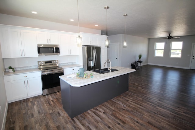 506 Mountain View Dr, Cascade, MT 59421 - kitchen with appliances with stainless steel finishes, dark wood-type flooring, an island with sink, white cabinetry, and recessed lighting