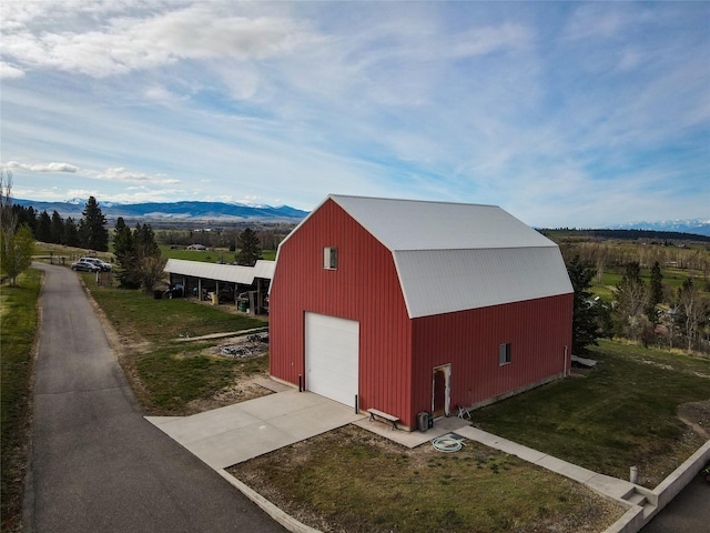 650 Hollibaugh Rd, Stevensville, MT 59870 - view of pole building featuring a mountain view, driveway, and a yard