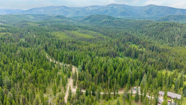6343 Packer Creek Rd, Haugan, MT 59842 - drone / aerial view of a heavily wooded area and a mountainous background