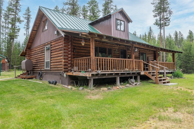6343 Packer Creek Rd, Haugan, MT 59842 - view of front of house with log siding, a front lawn, a metal roof, and a standing seam roof