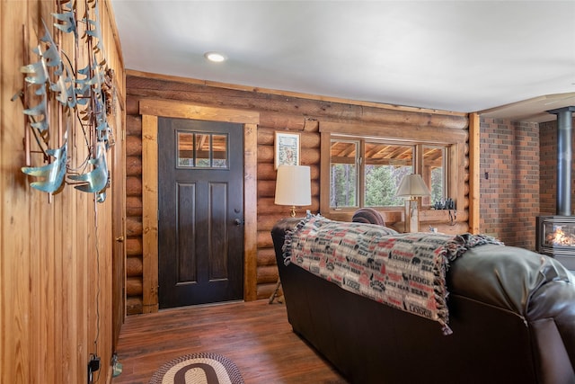 6343 Packer Creek Rd, Haugan, MT 59842 - entrance foyer with log walls, a wood stove, and wood finished floors