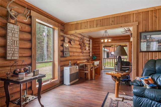 6343 Packer Creek Rd, Haugan, MT 59842 - living room with wood finished floors, heating unit, and log walls