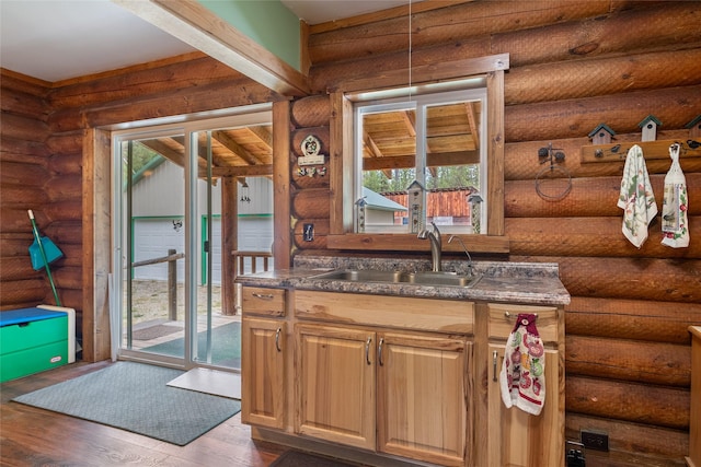 6343 Packer Creek Rd, Haugan, MT 59842 - kitchen featuring plenty of natural light, dark countertops, wood finished floors, and log walls
