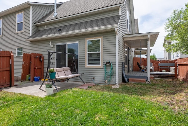 2331 W Sussex Ave, Missoula, MT 59801 - back of property featuring roof with shingles, a fenced backyard, a patio area, and a deck