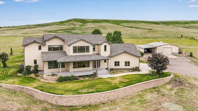 40 Butch Cassidy Loop, Great Falls, MT 59405 - view of front of house with a porch, an outbuilding, driveway, and a front lawn