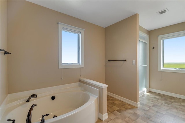 40 Butch Cassidy Loop, Great Falls, MT 59405 - bathroom featuring a bath, tile patterned floors, and a shower