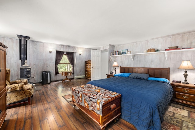 155 Lake Peter Ct, Kalispell, MT 59901 - bedroom featuring hardwood / wood-style flooring and a wood stove