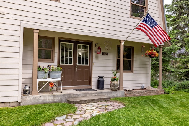155 Lake Peter Ct, Kalispell, MT 59901 - view of exterior entry with a lawn and a porch