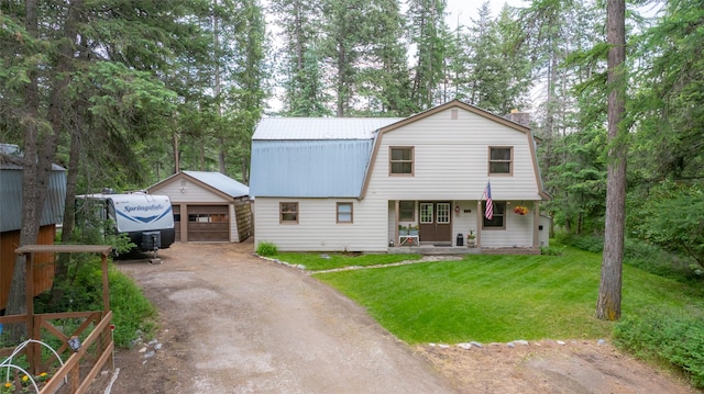 155 Lake Peter Ct, Kalispell, MT 59901 - colonial inspired home with a gambrel roof, an outbuilding, a front yard, a metal roof, and a detached garage
