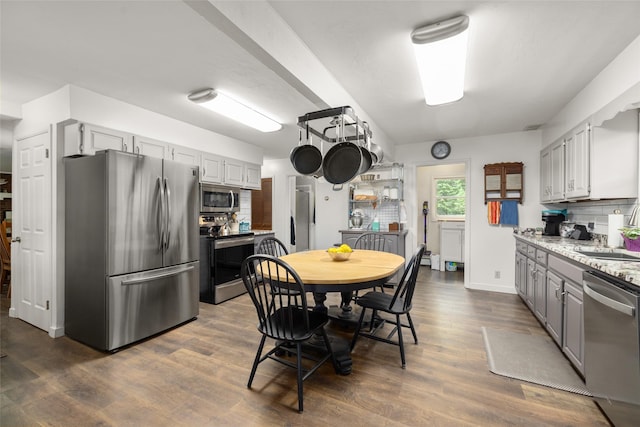 155 Lake Peter Ct, Kalispell, MT 59901 - kitchen featuring appliances with stainless steel finishes, backsplash, gray cabinets, and dark wood-type flooring