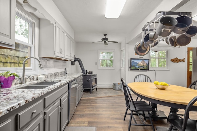 155 Lake Peter Ct, Kalispell, MT 59901 - kitchen featuring plenty of natural light, a wood stove, and gray cabinets