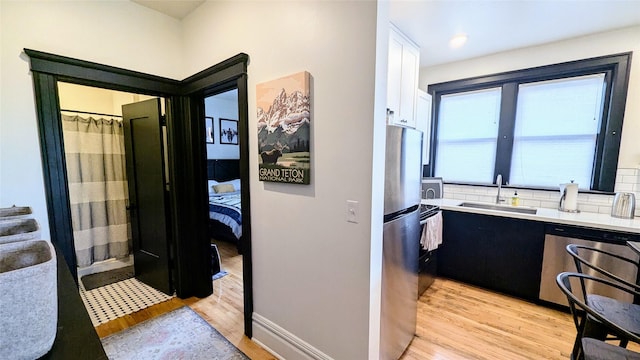 101 W Quartz St Unit 1A, Butte, MT 59701 - bathroom featuring wood finished floors, backsplash, connected bathroom, and vanity