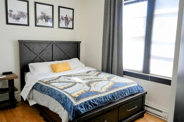 101 W Quartz St Unit 1A, Butte, MT 59701 - bedroom with a baseboard heating unit and light wood-style flooring